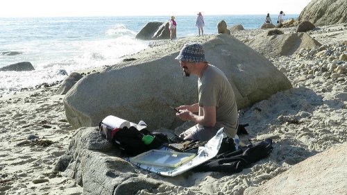 [Image: The artist demonstrates correct posture whilst painting ]